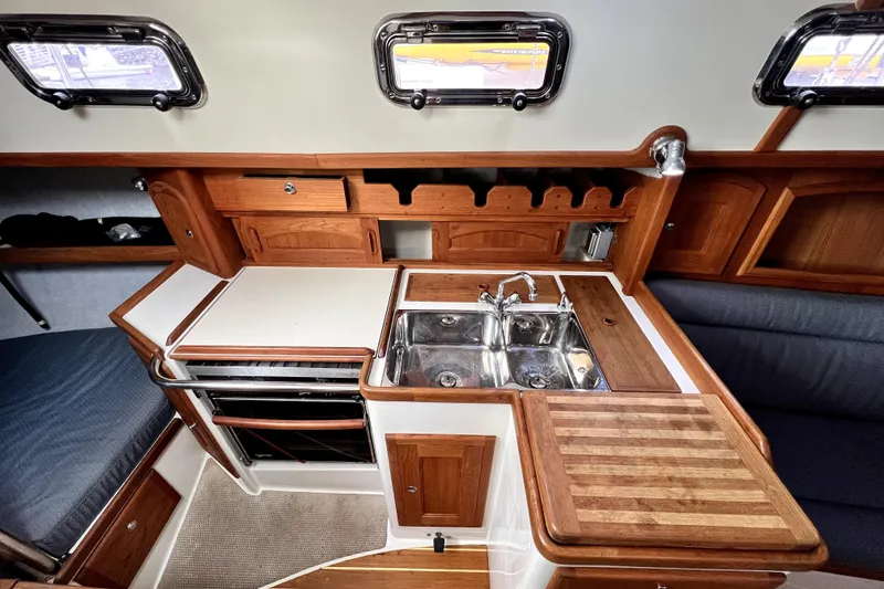  Yacht Photos Pics Cozy 2004 Pacific Seacraft 31 yacht interior with wooden cabinetry and dual sink.