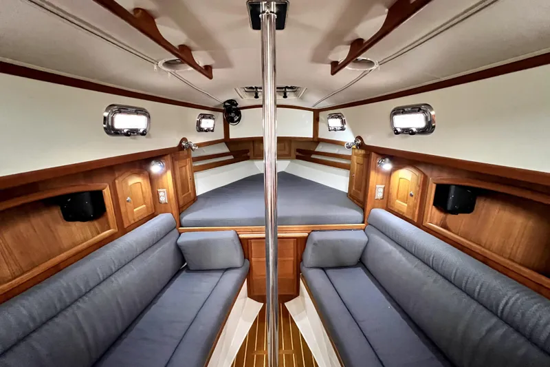  Yacht Photos Pics Interior of 2004 Pacific Seacraft 31 sailboat with cozy seating and wooden accents.