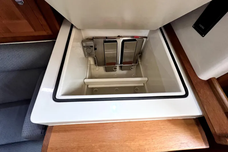  Yacht Photos Pics Open storage compartment in 2004 Pacific Seacraft 31 sailboat interior.