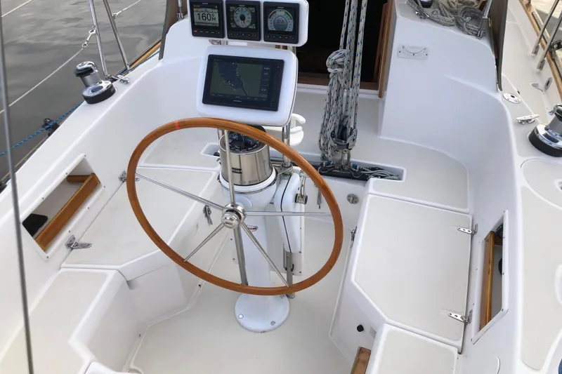 Murphy Yacht Photos Pics Cockpit of 2004 Pacific Seacraft 31 sailboat with wooden steering wheel and navigation instruments.