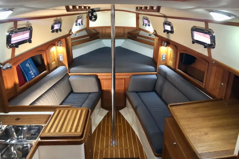 Murphy Yacht Photos Pics Interior of 2004 Pacific Seacraft 31 sailboat with cozy seating and wooden finishes.