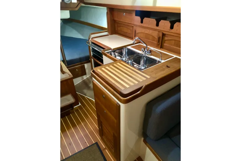 Murphy Yacht Photos Pics Interior of 2004 Pacific Seacraft 31 sailboat with wooden cabinetry and dual sink.
