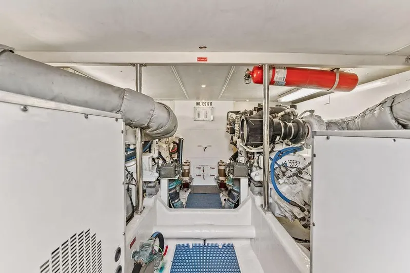 Five O' Clock Yacht Photos Pics Engine room of 2000 West Bay 58 Sonship yacht, featuring mechanical equipment and fire extinguisher.
