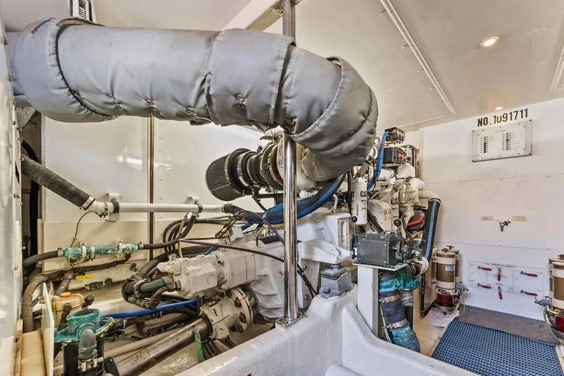 Five O' Clock Yacht Photos Pics Engine room of 2000 West Bay 58 Sonship yacht, showcasing mechanical components and systems.