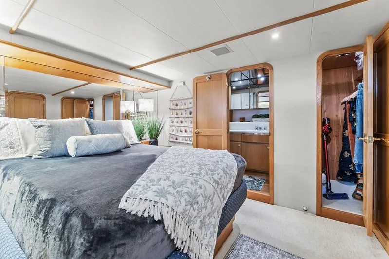 Five O' Clock Yacht Photos Pics Luxurious bedroom interior of 2000 West Bay 58 Sonship yacht with elegant decor and ensuite bathroom.
