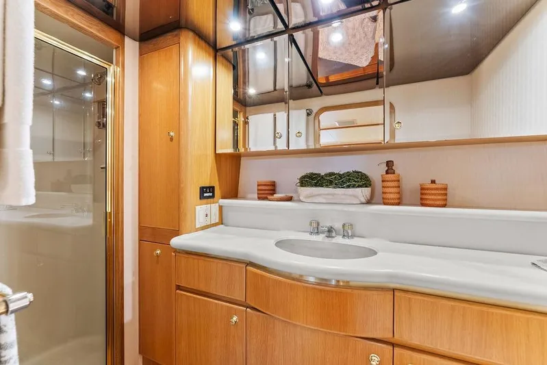 Five O' Clock Yacht Photos Pics Luxurious bathroom in 2000 West Bay 58 Sonship yacht with elegant wood cabinetry.