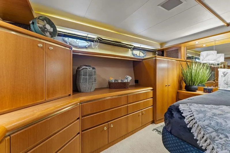 Five O' Clock Yacht Photos Pics Luxurious wooden interior of 2000 West Bay 58 Sonship yacht bedroom with storage and decor.