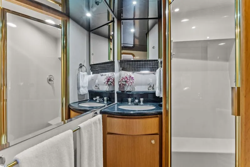 Five O' Clock Yacht Photos Pics Luxurious bathroom in 2000 West Bay 58 Sonship yacht with dual sinks and elegant decor.