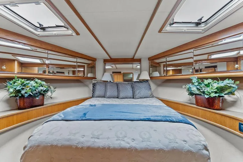 Five O' Clock Yacht Photos Pics Luxurious bedroom interior of 2000 West Bay 58 Sonship yacht with elegant decor.