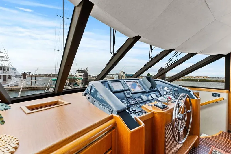 Five O' Clock Yacht Photos Pics Helm of 2000 West Bay 58 Sonship yacht with navigation controls and marina view.