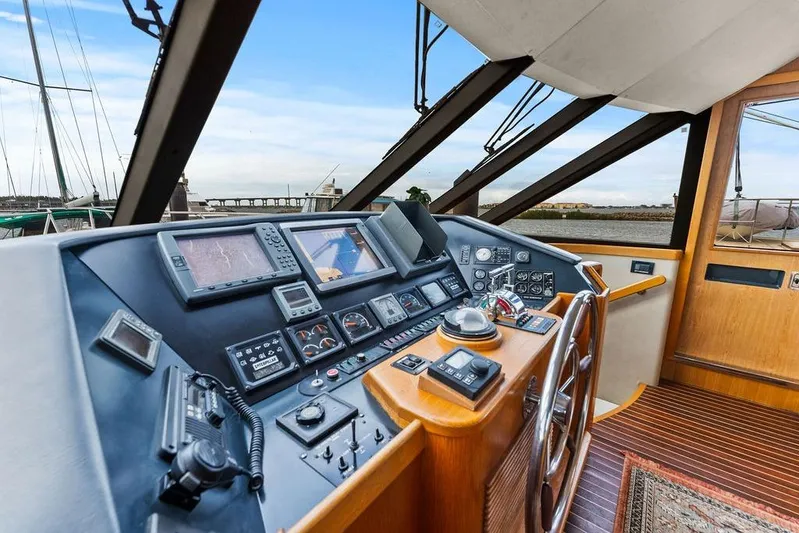 Five O' Clock Yacht Photos Pics Helm of 2000 West Bay 58 Sonship yacht with navigation instruments and wooden steering wheel.
