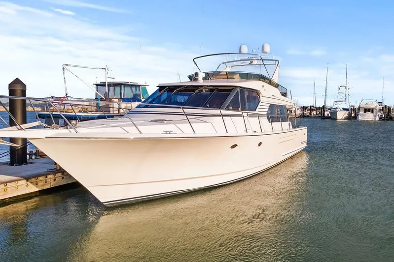 Five O' Clock Yacht Photos Pics Luxury 2000 West Bay 58 Sonship yacht docked in marina, clear blue sky.