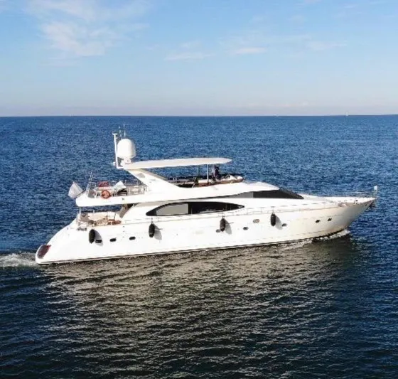 Yacht Photos Pics Luxurious 1998 Azimut Ultimate yacht cruising on open sea under clear blue sky.