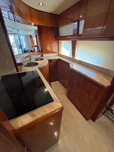  Yacht Photos Pics Luxurious kitchen in 1998 Azimut Ultimate yacht with modern appliances and wood cabinetry.