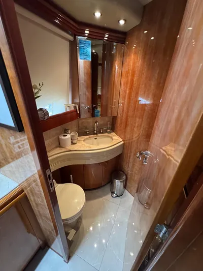  Yacht Photos Pics Luxurious bathroom in 1998 Azimut Ultimate yacht with wood paneling and modern fixtures.
