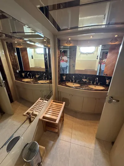  Yacht Photos Pics Luxurious bathroom in 1998 Azimut Ultimate yacht with dual sinks and elegant wood accents.