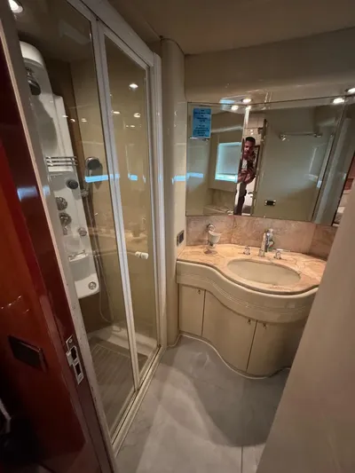  Yacht Photos Pics Luxurious bathroom in 1998 Azimut Ultimate yacht with modern fixtures and shower.