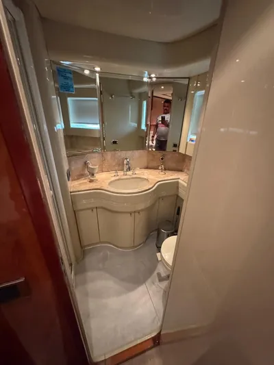  Yacht Photos Pics Luxurious bathroom in a 1998 Azimut Ultimate yacht with elegant fixtures and mirrored walls.