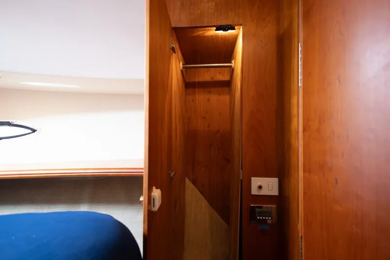 Blue Sapphire Yacht Photos Pics Interior of 2001 Silverton 410 Sport Bridge, featuring wooden closet and control panel.