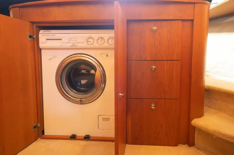 Blue Sapphire Yacht Photos Pics 2001 Silverton 410 Sport Bridge interior with built-in washer and wooden cabinetry.