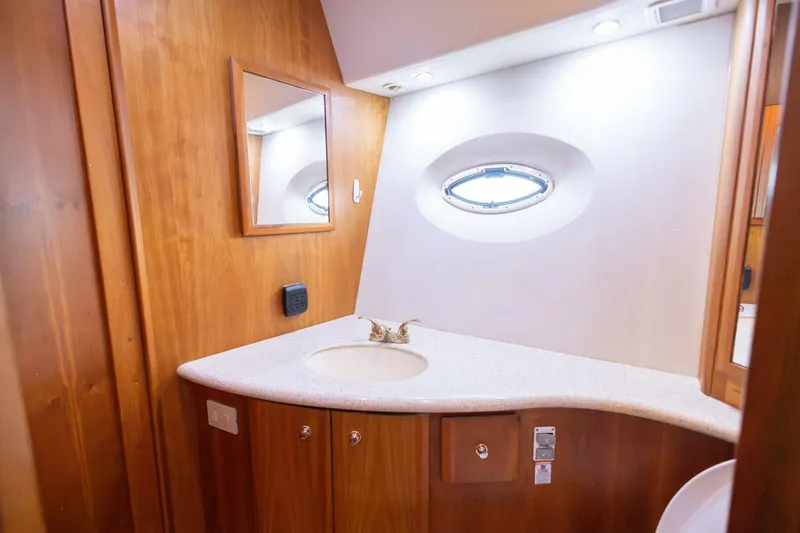 Blue Sapphire Yacht Photos Pics Luxurious bathroom interior of 2001 Silverton 410 Sport Bridge yacht with wooden cabinetry.
