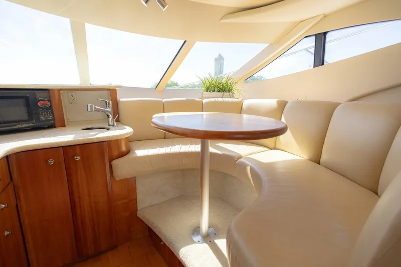 Blue Sapphire Yacht Photos Pics Interior of 2001 Silverton 410 Sport Bridge with cozy seating and kitchenette.