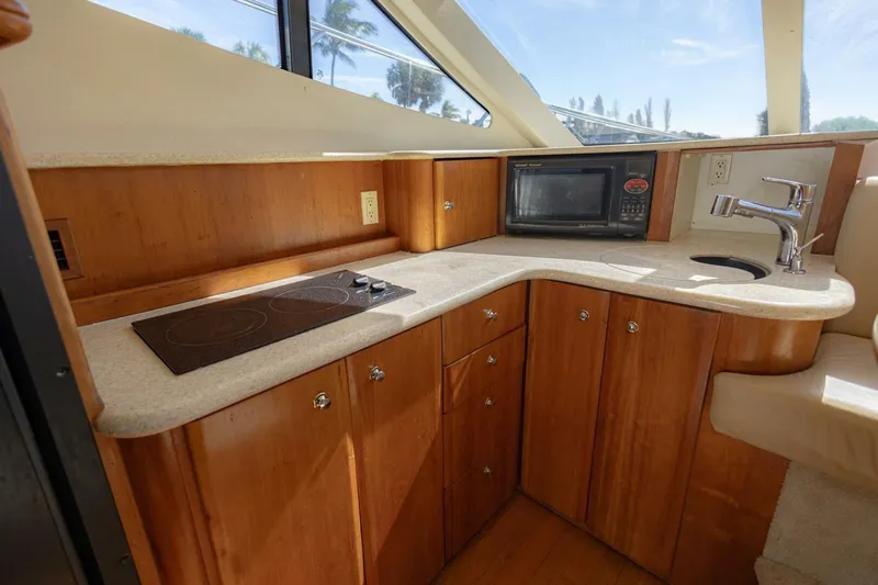Blue Sapphire Yacht Photos Pics 2001 Silverton 410 Sport Bridge kitchen with stove, microwave, and sink.
