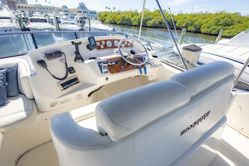 Blue Sapphire Yacht Photos Pics 2001 Silverton 410 Sport Bridge yacht helm with luxurious seating and modern controls.