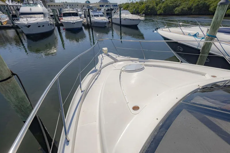 Blue Sapphire Yacht Photos Pics 2001 Silverton 410 Sport Bridge yacht docked at marina, surrounded by other boats.