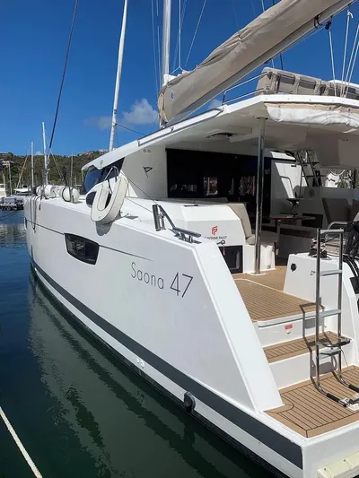 Hourglass Yacht Photos Pics 2020 Fountaine Pajot Saona 47 catamaran docked, showcasing sleek design and spacious deck.