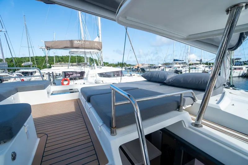 Hourglass Yacht Photos Pics 2020 Fountaine Pajot Saona 47 catamaran with spacious deck and comfortable seating at marina.