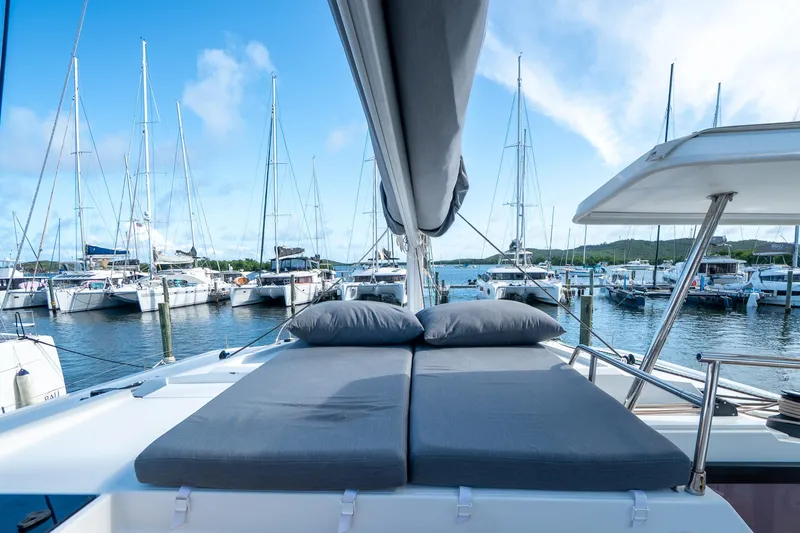 Hourglass Yacht Photos Pics Luxury Fountaine Pajot Saona 47 catamaran with sunbeds, docked in a marina, 2020 model.