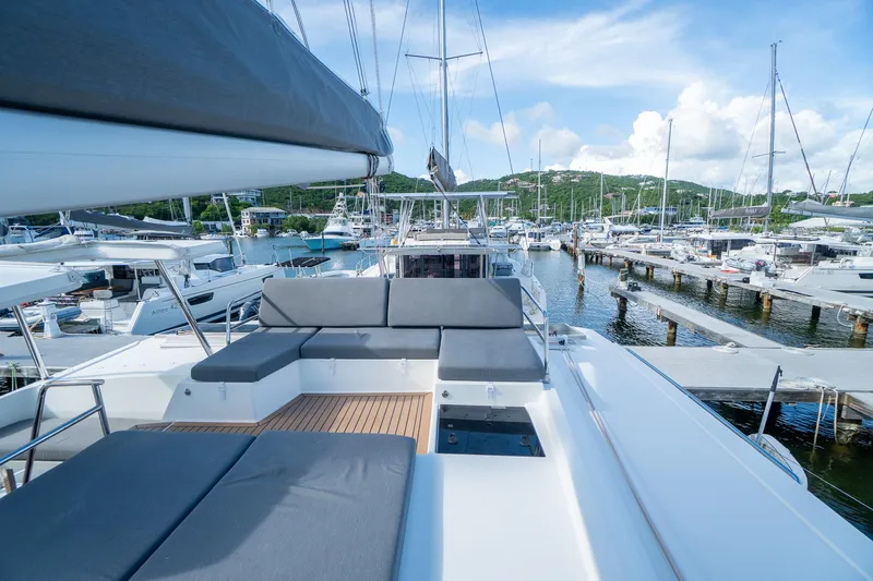 Hourglass Yacht Photos Pics Fountaine Pajot Saona 47 yacht, 2020 model, docked in a marina with scenic views.