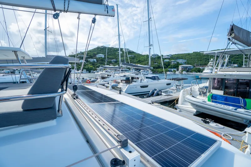 Hourglass Yacht Photos Pics 2020 Fountaine Pajot Saona 47 catamaran with solar panels docked in a marina.