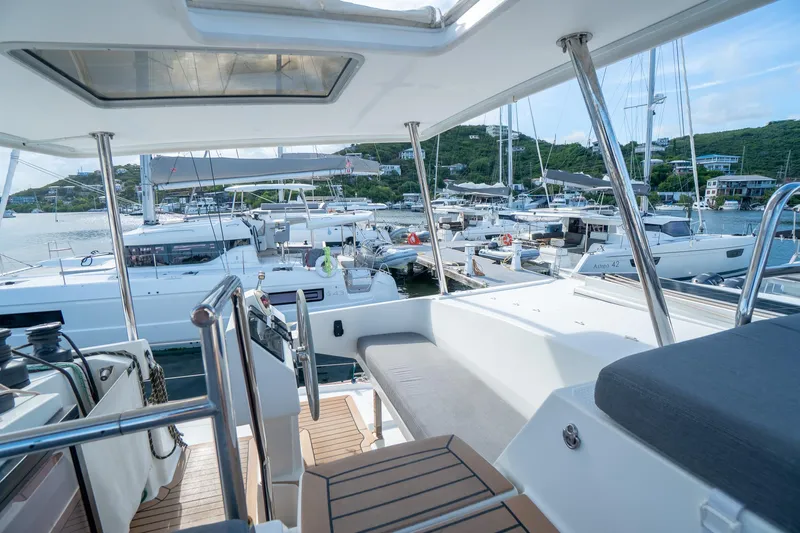Hourglass Yacht Photos Pics 2020 Fountaine Pajot Saona 47 catamaran docked in a marina, showcasing spacious deck and seating.