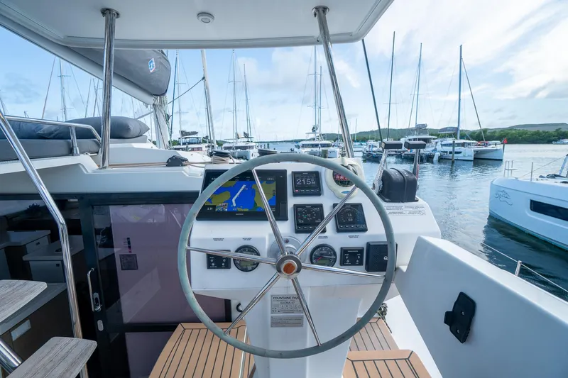 Hourglass Yacht Photos Pics Helm of 2020 Fountaine Pajot Saona 47 catamaran with navigation instruments, docked in marina.