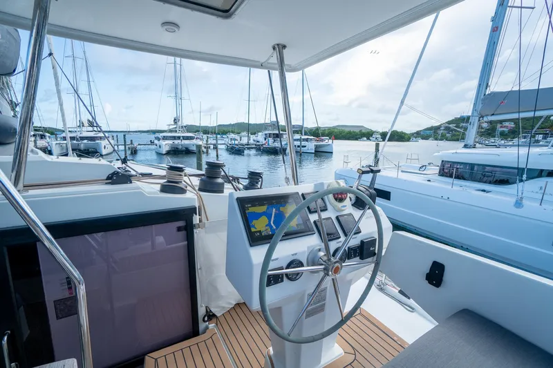 Hourglass Yacht Photos Pics Helm of 2020 Fountaine Pajot Saona 47 catamaran in marina, featuring navigation equipment.