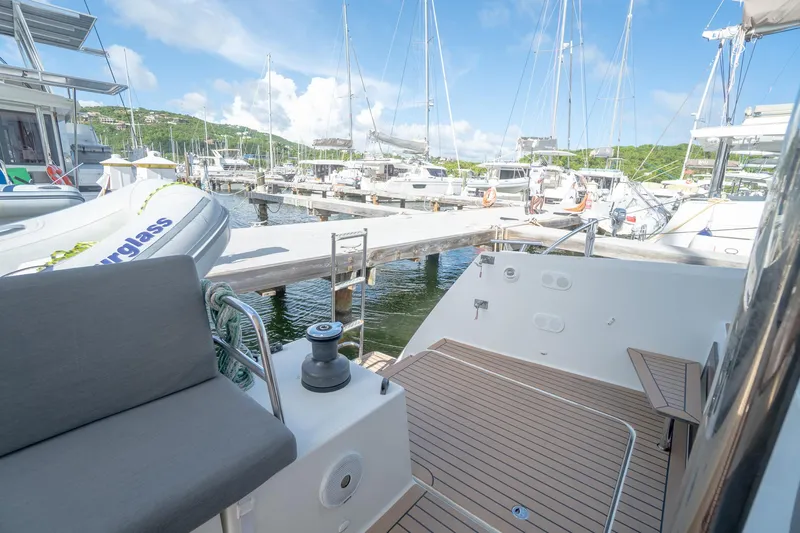 Hourglass Yacht Photos Pics 2020 Fountaine Pajot Saona 47 yacht docked at a marina, featuring a spacious deck.