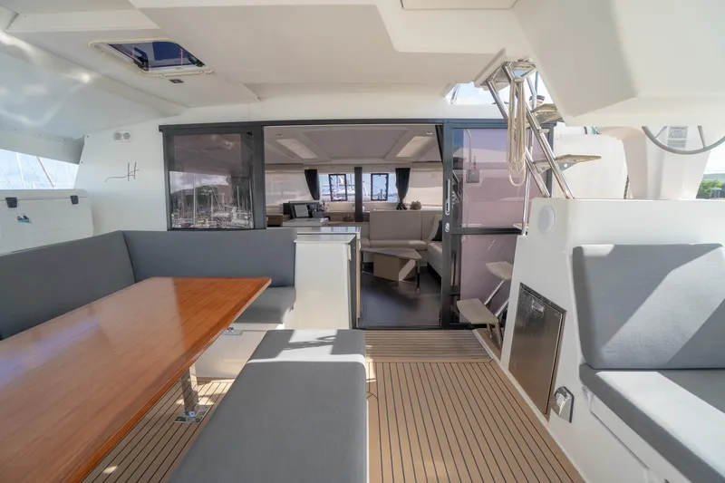 Hourglass Yacht Photos Pics Spacious interior of 2020 Fountaine Pajot Saona 47 catamaran with modern seating and dining area.