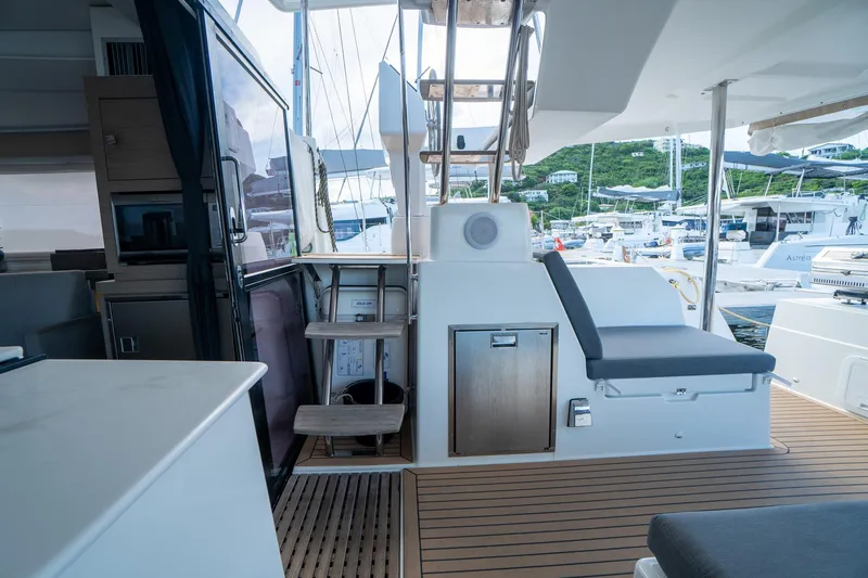 Hourglass Yacht Photos Pics Modern Fountaine Pajot Saona 47 yacht interior with wooden deck and seating, 2020 model.