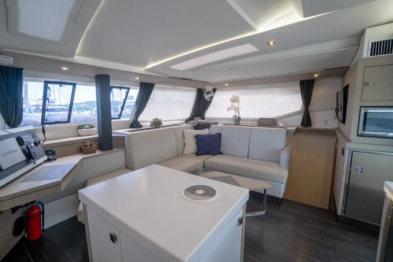 Hourglass Yacht Photos Pics Interior of 2020 Fountaine Pajot Saona 47 catamaran with modern seating and kitchen area.