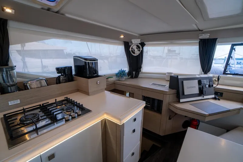 Hourglass Yacht Photos Pics Modern kitchen interior of 2020 Fountaine Pajot Saona 47 catamaran with appliances and sleek design.