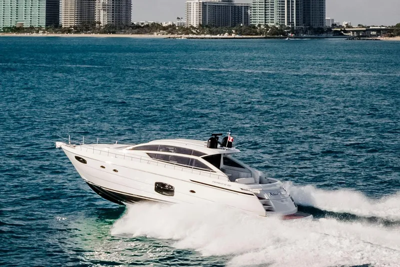 Sea Suite Yacht Photos Pics 2021 Pershing 62 yacht cruising on ocean near city skyline.