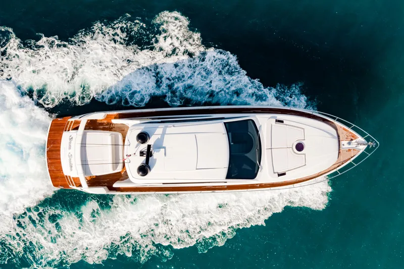 Sea Suite Yacht Photos Pics Aerial view of 2021 Pershing 62 yacht cruising on blue ocean waters.