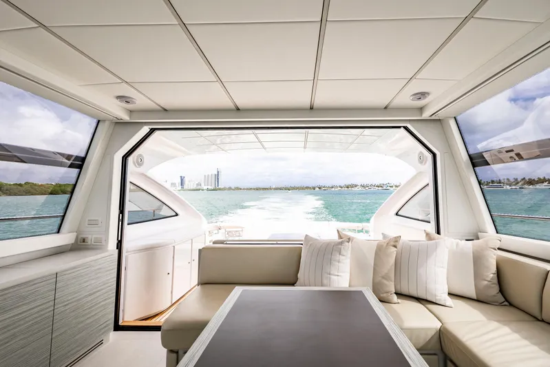 Sea Suite Yacht Photos Pics Luxurious interior of 2021 Pershing 62 yacht with ocean view and elegant seating.