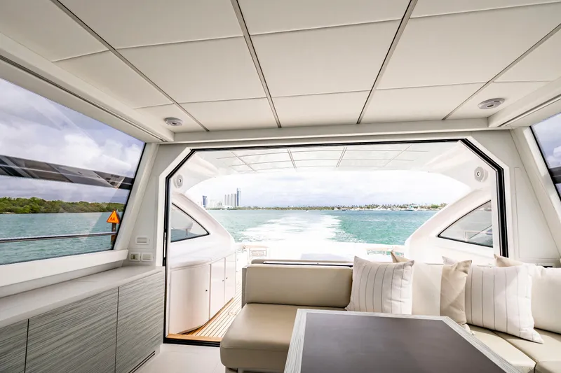 Sea Suite Yacht Photos Pics Luxurious interior of 2021 Pershing 62 yacht with ocean view through large windows.