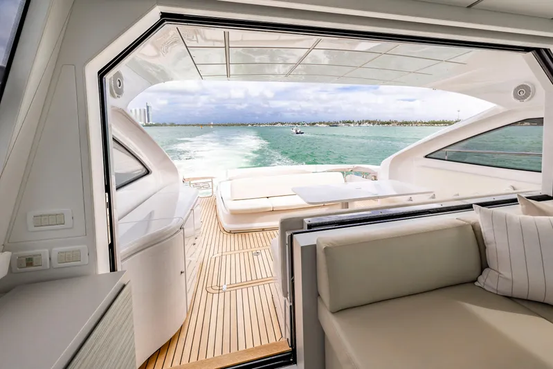 Sea Suite Yacht Photos Pics Luxurious 2021 Pershing 62 yacht interior with open deck view, cruising on serene waters.