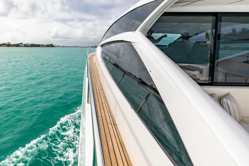 Sea Suite Yacht Photos Pics 2021 Pershing 62 yacht cruising on turquoise waters, showcasing sleek design and luxury.