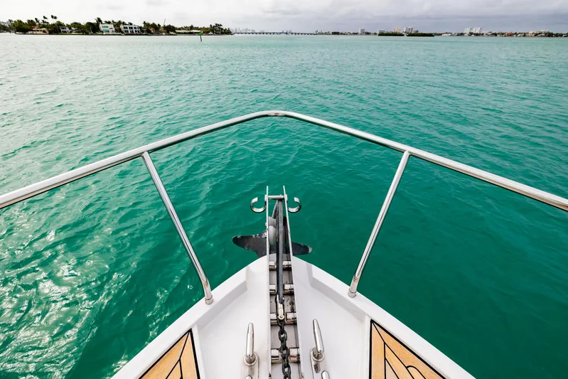 Sea Suite Yacht Photos Pics Bow view of 2021 Pershing 62 yacht on turquoise water.