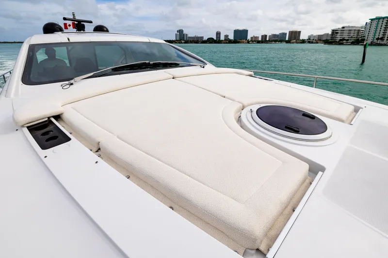 Sea Suite Yacht Photos Pics 2021 Pershing 62 yacht with sunbathing deck, cruising near city skyline.